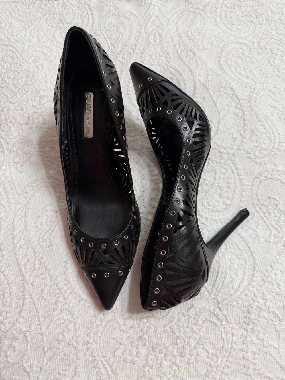 BCBGeneration Size 9M Black Laser-Cut Pointed Toe Stilettos with Silver Grommets